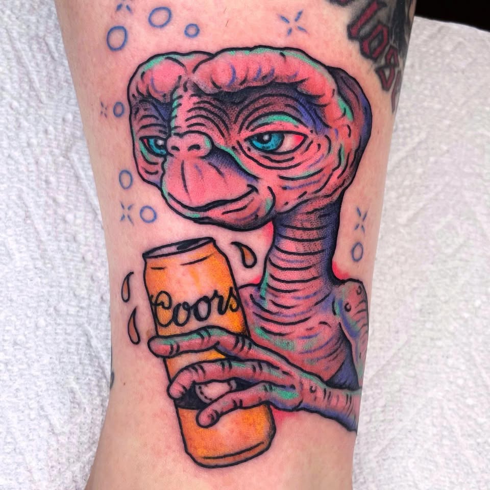 E.T. holding Coors beer tattoo
