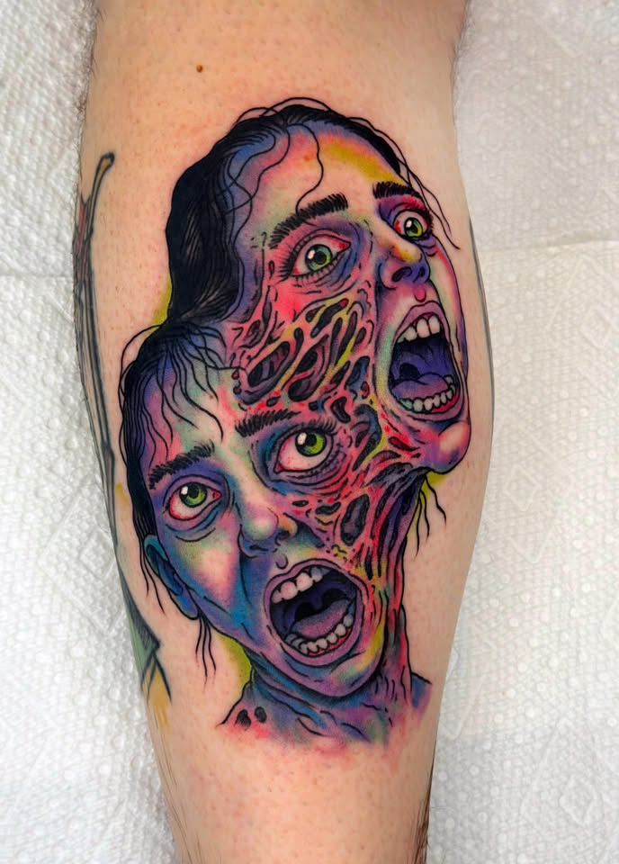 Three-eyed melting face horror tattoo