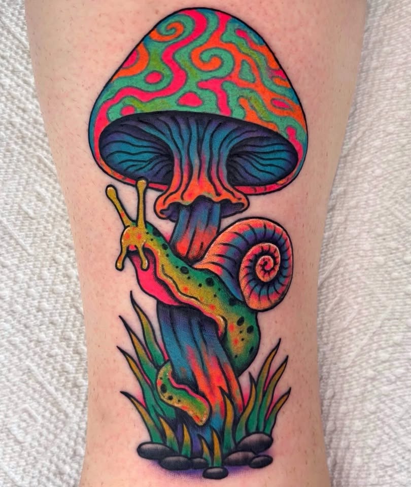 Psychedelic mushroom and snail tattoo